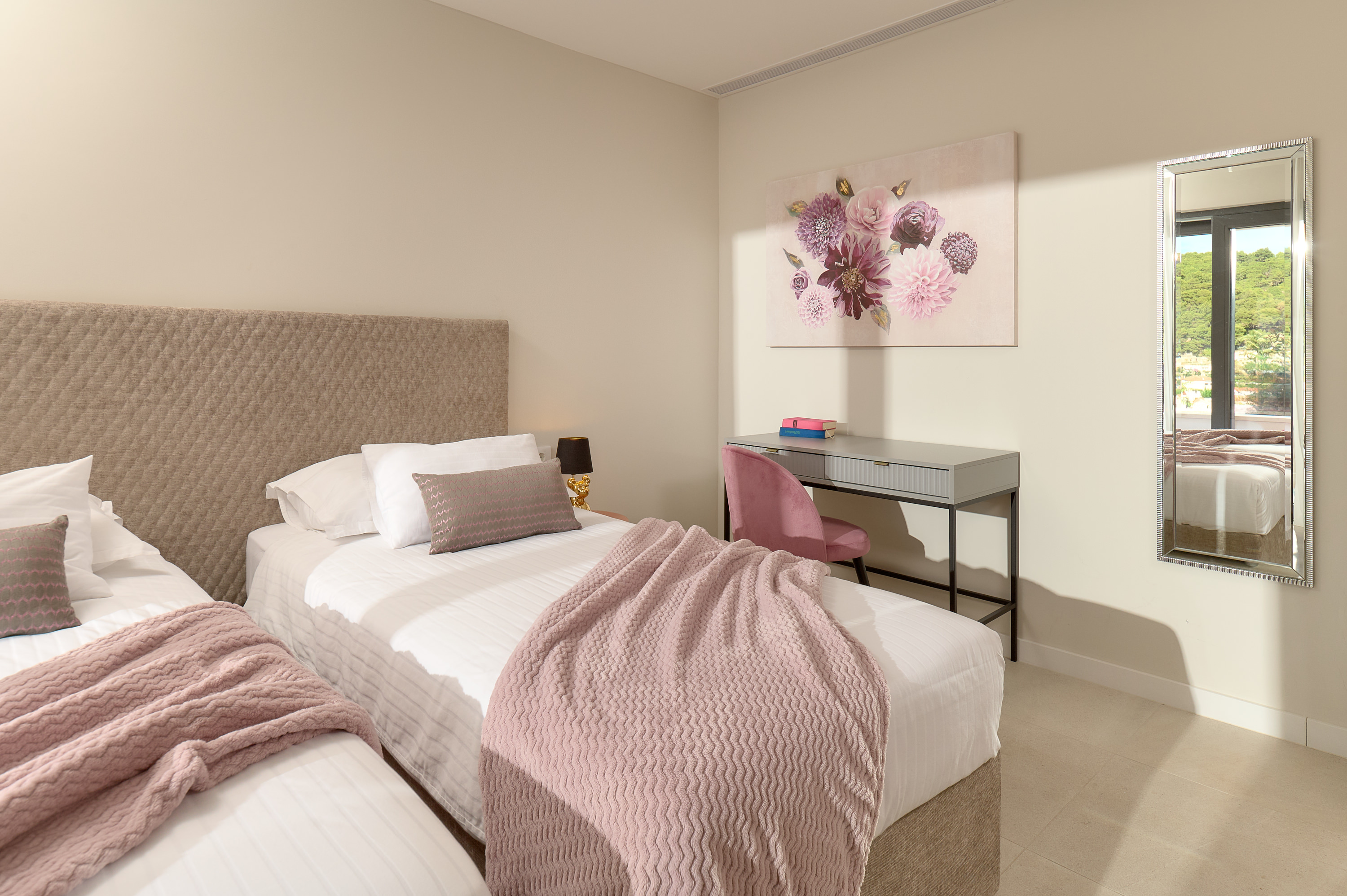 Bedroom 1 with large bed and balcony with chairs and table