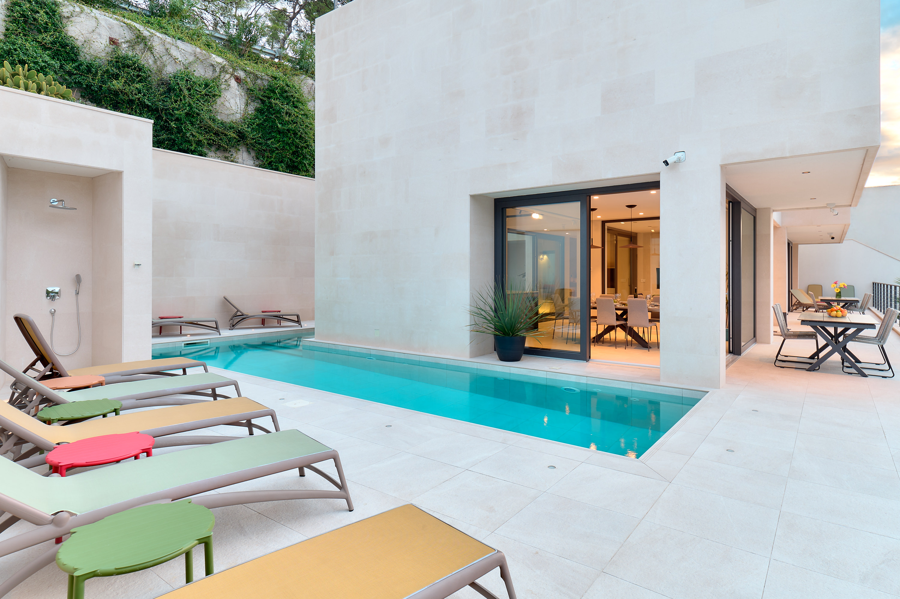 Front view of the L-shaped pool and outdoor shower